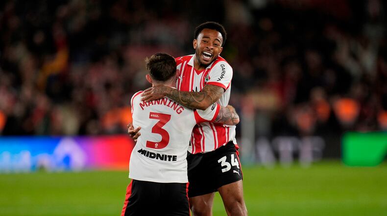 Southampton's Welington, right, and Ryan Manning celebrate at the final whistle in the EFL Championship play off semifinal soccer game between Southampton and Middlesbrough, Tuesday, May 12, 2026, in, Southampton, England. (Andrew Matthews/PA via AP)