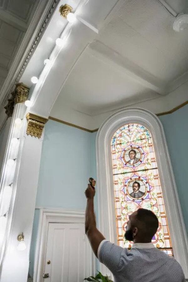 Anthony Kinslow uses an infrared thermometer to measure the heat put out by an LED light bulb at First African Baptist Church. (Photo Courtesy of Justin Taylor/The Current)