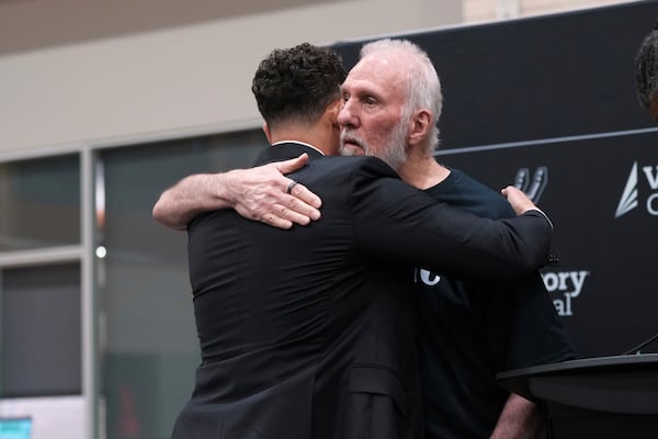 FILE - Former San Antonio Spurs head coach Gregg Popovich, right, hugs Mitch Johnson, left, the new head coach of the San Antonio Spurs NBA basketball team, in San Antonio, May 5, 2025. (AP Photo/Eric Gay)