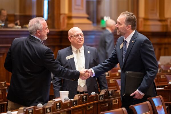 (L-R) State Rep. Matt Barton, R-Calhoun, greets new Rep. Eric Gisler, D-Watkinsville, in the House of Representatives on the first day of the legislative session at the Capitol in Atlanta on Monday, Jan. 12, 2026. (Arvin Temkar/AJC)