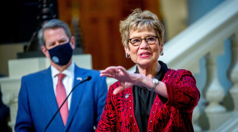 With Gov. Brian Kemp looking on, Dr. Kathleen Toomey, Georgia's public health commissioner, gives an update on distribution of the COVID-19 vaccine on Thursday. STEVE SCHAEFER FOR THE ATLANTA JOURNAL-CONSTITUTION