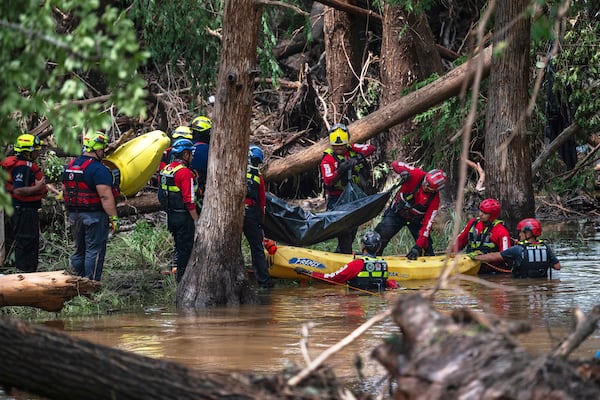 FILE - Firefighters from Ciudad Acuña, Mexico, load a body into a raft as they prepare for a water recovery along the Guadalupe River days after a flash flood swept through the area July 7, 2025, in Ingram, Texas. (AP Photo/Eli Hartman, File)