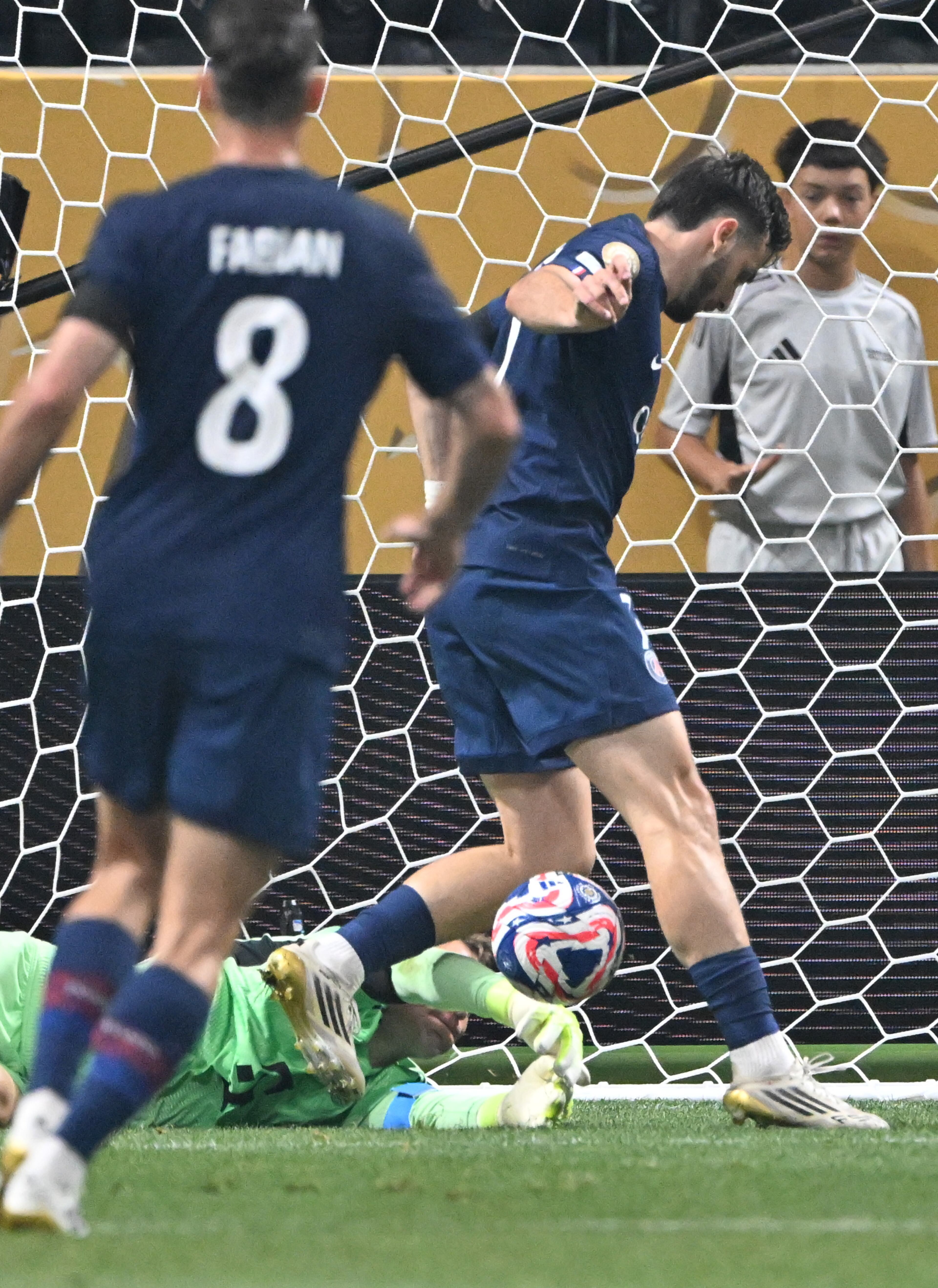 Bayern Munich goalkeeper Manuel Neuer (ground) blocks a shot by Paris Saint-Germain's Khvicha Kvaratskhelia (right) during the first half of the Club World Cup quarterfinals match at Mercedes-Benz Stadium on Saturday, July 5, 2025, in Atlanta. (Hyosub Shin/AJC)