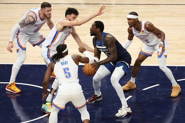 Minnesota Timberwolves forward Julius Randle (30) controls the ball against Oklahoma City Thunder defenders during the first half of Game 3 of the Western Conference finals of the NBA basketball playoffs, Saturday, May 24, 2025, in Minneapolis. (AP Photo/Matt Krohn)
