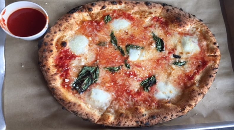 Inizio's version, with a beautifully freckled crust, comes with a little cup of marinara on the side.
(Kathleen Purvis/Charlotte Observer/TNS)