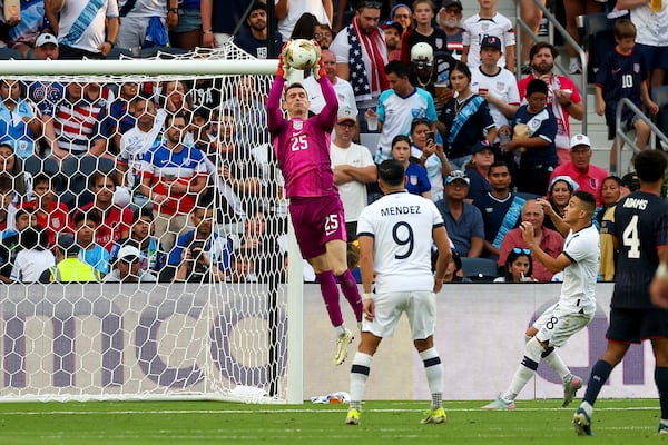 United States goalkeeper Matthew Freese (25) makes a save while Guatemala forward Rubio Mendez (9) and Oscar Santis (18) watch during the second half of a CONCACAF Gold Cup semifinal soccer match, Wednesday, July 2, 2025, in St. Louis. (AP Photo/Scott Kane)