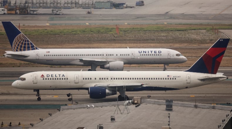 A United Boeing 757 taxis past a Delta Airlines Boeing 757 at Los Angeles International Airport May 29, 2015. (Photo by John Gress/Corbis via Getty Images)