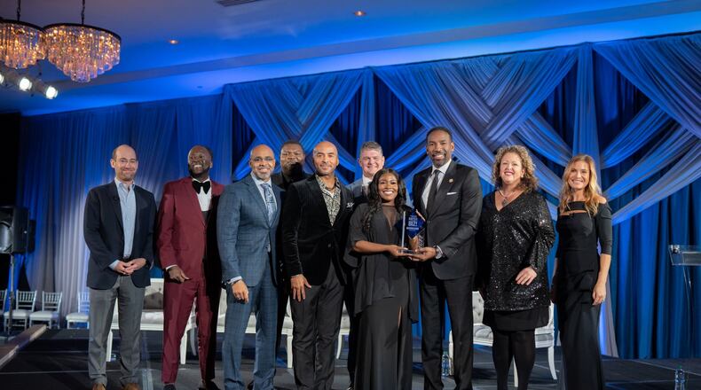 Atlanta Mayor Andre Dickens, a board member of Goodwill North Georgia, announced young entrepreneur, Deju Green, as the winner of a “Battle of the Biz” competition. She was awarded a $10,000 prize. Pictured from left to right: David Roemer CEO of  Ideas United, James Thomas Goodwill graduate and founder of Montfichet & Company, Dr. Kofi Smith Chair of Goodwill of North Georgia’s board of directors and CEO of Keystone Management, Wesley Chenoweth Goodwill graduate and founder of Grizzly Delivery, Keith Parker President and CEO at Goodwill of North Georgia, Clark Dean Executive Managing Director at Transwestern, Deju Green Goodwill Graduate, 2022 Battle of the BIZ! winner, and founder of Edge Tutoring, Andre Dickens City of Atlanta Mayor, Alicen Blair Goodwill of North Georgia board of directors and Principal, Consumer and Board & CEO Practices at Korn Ferry, Jen Carfagno Battle of the BIZ! emcee and meteorologist at the Weather Channel. Courtesy Goodwill North Georgia