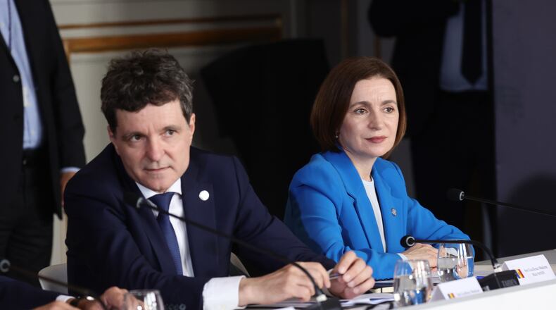 Romanian President Nicusor Dan, left, and Moldovan President Maia Sandu attend the Coalition of the Willing summit on security guarantees for Ukraine, at the Hotel des Invalides in Paris, Monday, July 2026. (Teresa Suares/Pool Photo via AP)