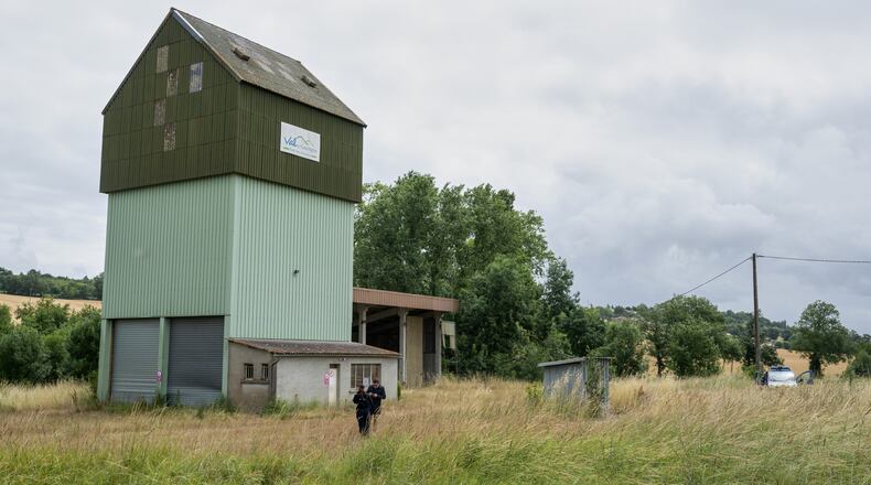 French police guard a farm silo where a body was found yesterday during the search to find missing 11 year-old girl Lyhanna in Puycasquier, southwestern France, Friday, June,5, 2026. (AP Photo/Frederic Lancelot)