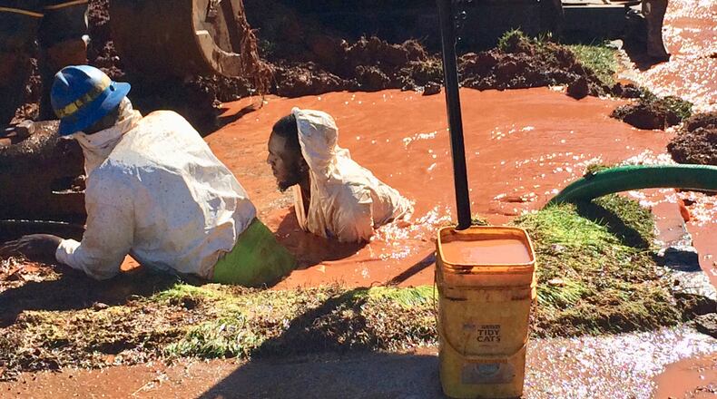 A DeKalb County work crew wades in shoulder-deep water to repair a broken water main on Chesterfield Lane Thursday. The water main break caused low water pressure for residents in the Briarlake area of north DeKalb County. CHRIS JOYNER / CJOYNER@AJC.COM