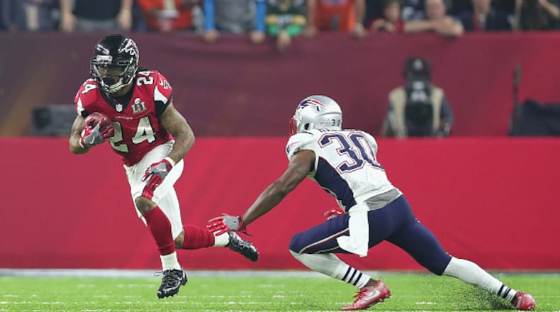 Falcons running back Devonta Freeman avoids a tackle by Duron Harmon during Super Bowl 51 at NRG Stadium Feb. 5, 2017 in Houston.