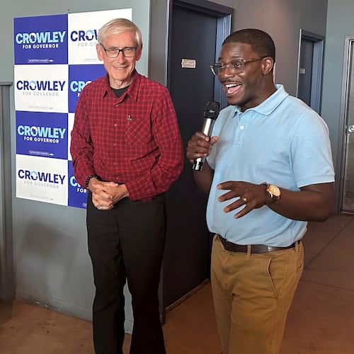 Wisconsin Gov. Tony Evers, center, campaigns with Democratic candidate for Governor David Crowley, right, Monday, Aug. 10, 2026, in Madison, Wis. (AP Photo/Scott Bauer)