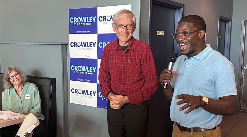 Wisconsin Gov. Tony Evers, center, campaigns with Democratic candidate for Governor David Crowley, right, Monday, Aug. 10, 2026, in Madison, Wis. (AP Photo/Scott Bauer)