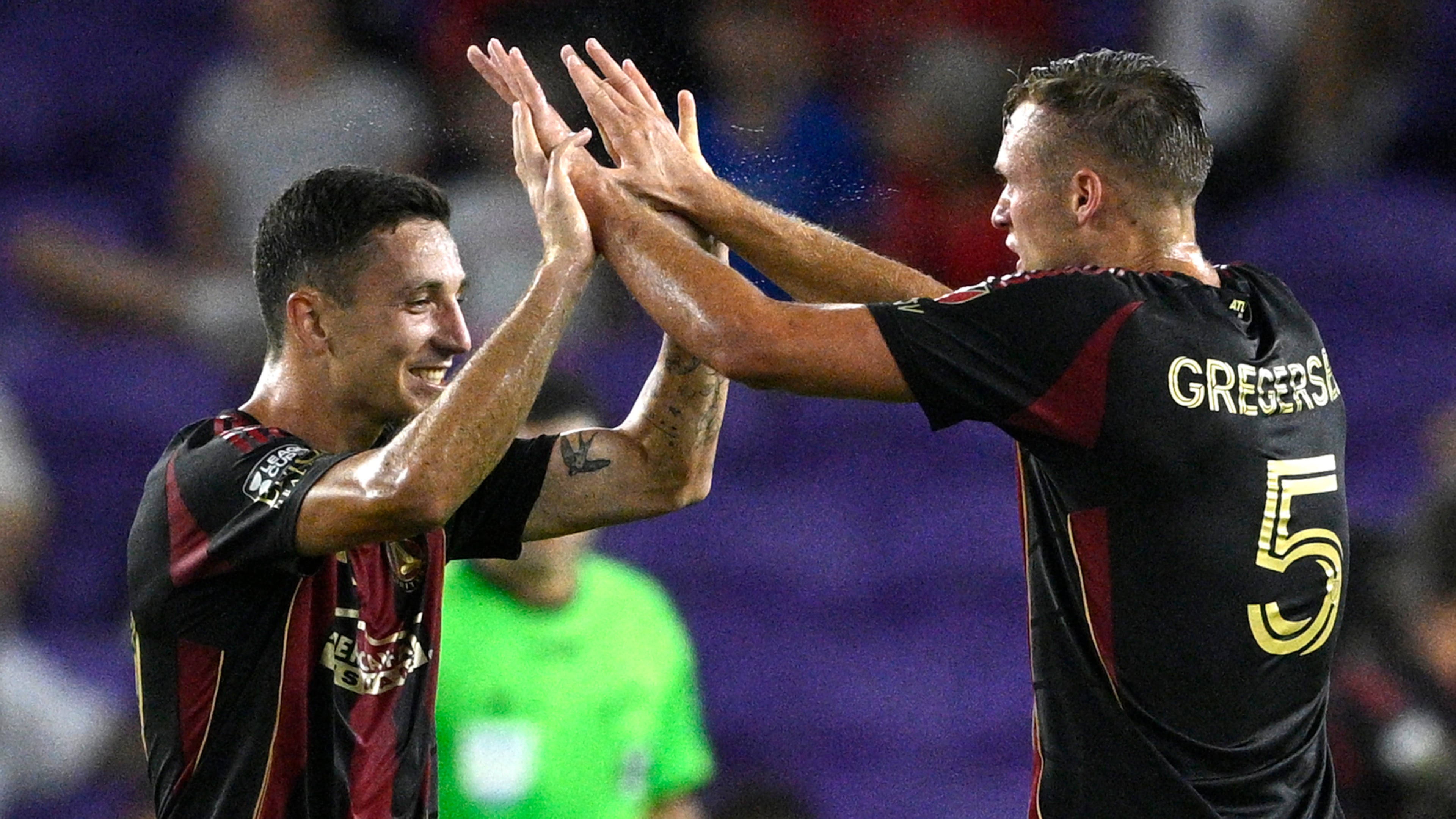 Atlanta United's Bartosz Slisz, left, and Stian Rode Gregersen (right) celebrate after an own goal by Puma UNAM goalkeeper Keylor Navas during the first half of a Leagues Cup soccer match, Saturday, Aug. 2, 2025, in Orlando, Fla. (Phelan M. Ebenhack/AP)