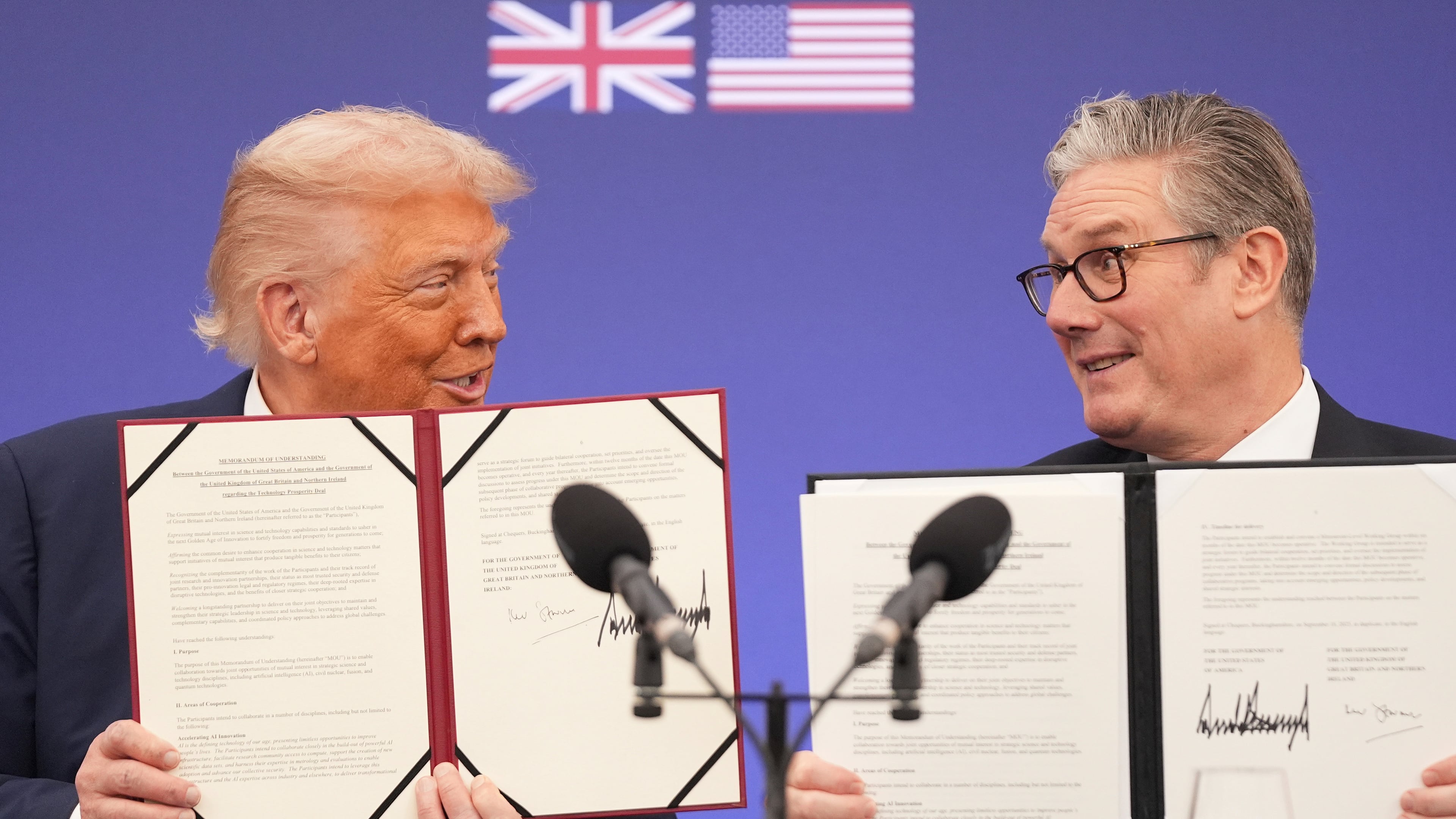 President Donald Trump and Britain's Prime Minister Keir Starmer smile, holding a memorandum of understanding between the governments of the two countries after a business roundtable at Chequers near Aylesbury, England, Thursday, Sept. 18, 2025. (AP Photo/Evan Vucci)