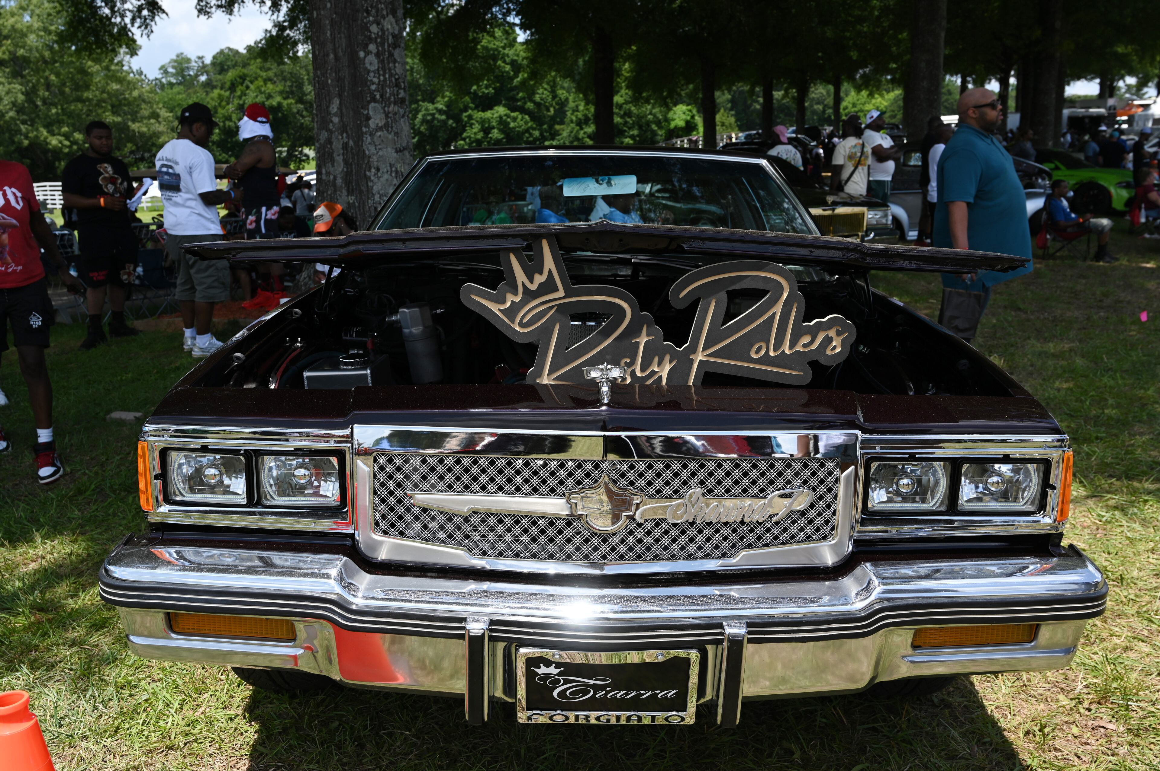 Attendees walk through some of classic/custom and luxury vehicles on Rick Ross’s property during the 4th Annual Rick Ross Car and Bike Show, Saturday, June 7, 2025, in Fayetteville. The 4th Annual Rick Ross Car and Bike Show will include a vendor market with more than 30 vendors, food trucks, fleets of classic/custom automobiles, luxury vehicles, boats, RVs and trailers on the front of the mansion. Stage performances include Plies, Ross' new signee Nino Breeze and Ross himself. (Hyosub Shin / AJC)