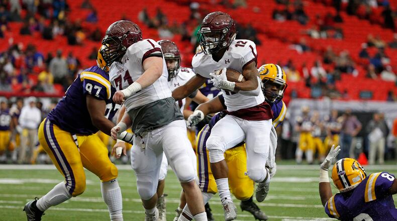 Benedictine running back John Wesley Kennedy III (12) rushes for a touchdown run in the first half of the Class AA state championship game Saturday at the Georgia Dome against Fitzgerald. (Jason Getz for the AJC)