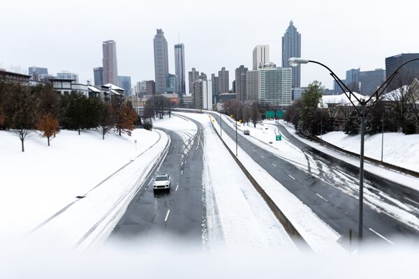 A view of the Atlanta skyline at Jackson Street Bridge in Atlanta on Friday, Jan. 10, 2025. Snow is covering metro Atlanta as a winter storm bears down across North Georgia. (Arvin Temkar/AJC)