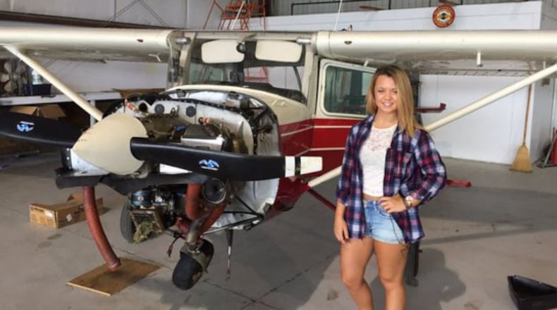 Sierra Lund stands with the Cessna 150 she crash-landed recently on a Peachtree City golf course. (Credit: Channel 2 Action News)