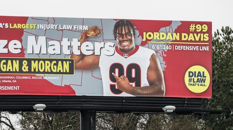 March 9, 2022 Atlanta: UGA defensive tackle, Jordan Davis appears on this southbound I-75/I-85 legal firm’s billboard near University Avenue in Atlanta, Georgia on Wednesday, March 9, 2022. (John Spink / John.Spink@ajc.com)