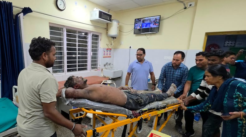 An injured person is moved for treatment at a hospital after the collapse of an under-construction tunnel at a hydropower project in Chamoli district of Uttarakhand, India, Thursday, Aug. 13, 2026. (AP Photo/Surendra Rawat)