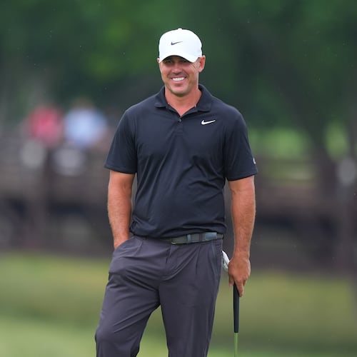 Brooks Koepka smiles while standing on the ninth green during of the first round of the Byron Nelson golf tournament in McKinney, Texas, Thursday, May 21, 2026. (AP Photo/LM Otero)