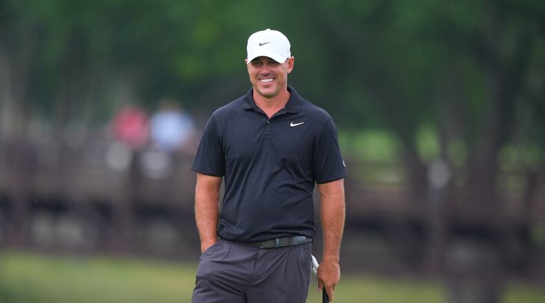 Brooks Koepka smiles while standing on the ninth green during of the first round of the Byron Nelson golf tournament in McKinney, Texas, Thursday, May 21, 2026. (AP Photo/LM Otero)
