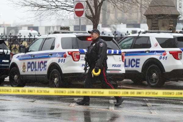 An Ottawa Police Service officer works the scene after a man barricaded himself in Parliament Hill in Ottawa, Ontario, Saturday, April 5, 2025. (Spencer Colby/The Canadian Press via AP)