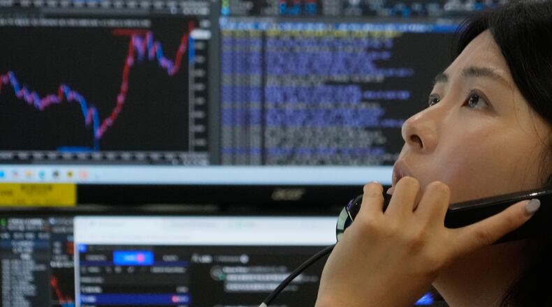 A currency trader talks on the phone at the foreign exchange dealing room of the Hana Bank headquarters in Seoul, South Korea, Monday, June 1, 2026. (AP Photo/Ahn Young-joon)