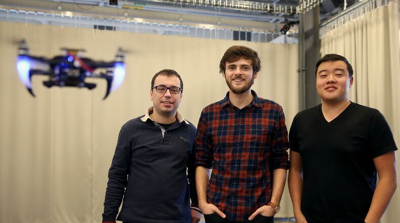 From left, researchers Giuseppe Loianno, Aaron Weinstein and Adam Cho stand for a portrait among a swarm of quadrotor drones using visual inertial odometry on Thursday, Jan. 25, 2018 at the Pennovation Center in Forgotten Bottom. Penn Engineering’s GRASP, or general robotics, automation, sensing & perception lab, has programmed the drones to fly into formations autonomously using a combination of a camera, accelerometer and gyrometer rather than GPS. (Tim Tai/Philadelphia Inquirer/TNS)
