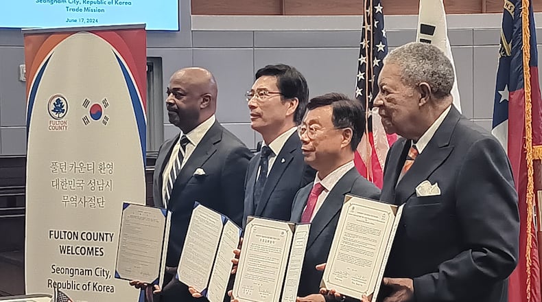 Officials from Seongnam, South Korea, and Fulton County hold copies of formal agreements on cooperation and cultural exchange Monday, June 17, 2024.
From left to right: Kwanza Hall, vice chair of Develop Fulton; Euijoon Lee, president and CEO of Seongnam Industry Promotion Agency; Seongnam Mayor Sang-Jin Shin; and Fulton Commission Chair Robb Pitts.
The Korean delegation is looking at cities including College Park, East Point and Fairburn as possible sites for high-tech investments.