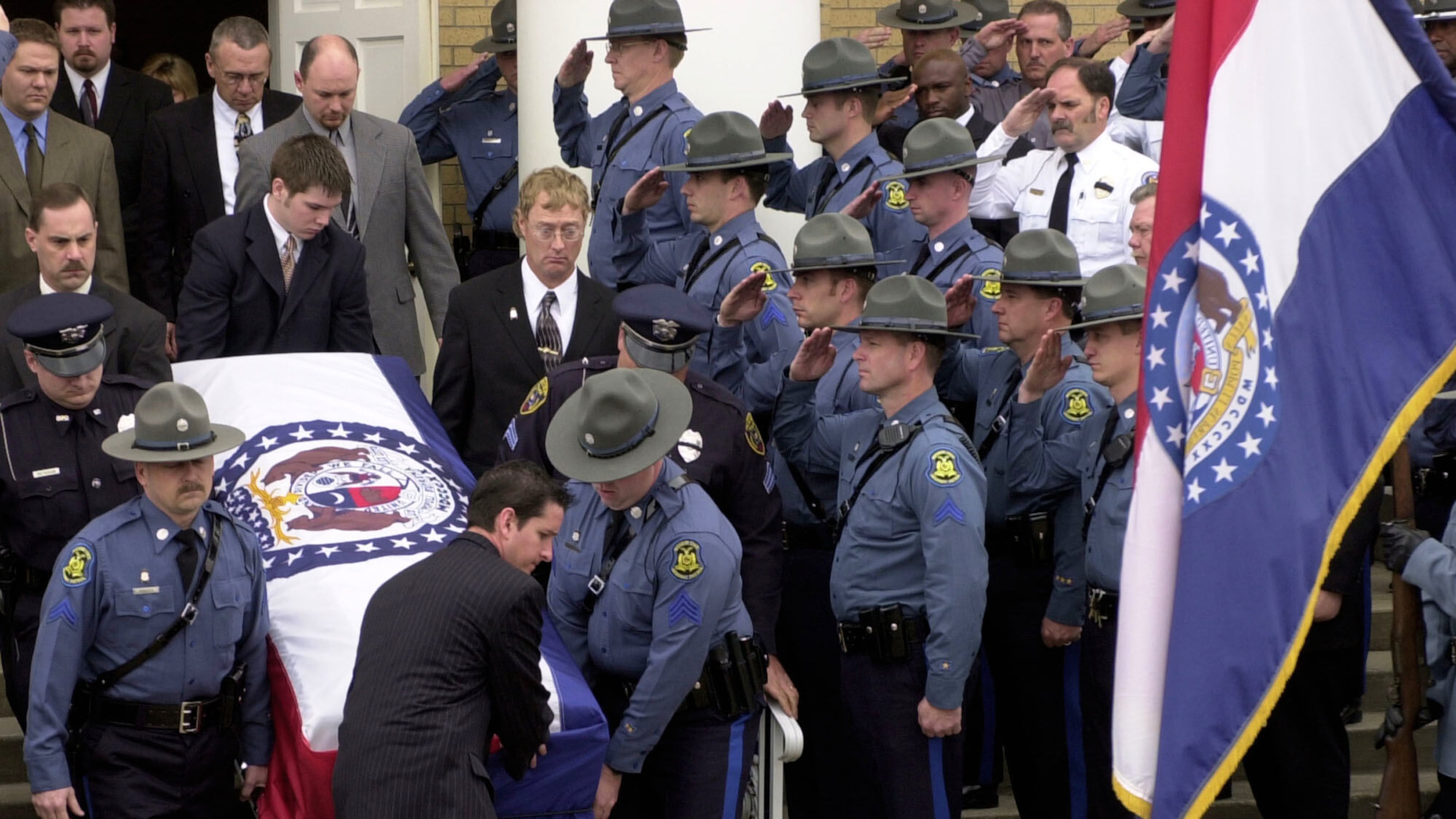 FILE - Members of the Missouri State Highway Patrol salute the body of fellow officer Sgt. Carl ''Dewayne'' Graham Jr., after funeral services March 24, 2005, in Dexter, Mo. (AP Photo/Bill Boyce, File)