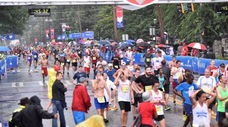 After 6.2 miles through the heart of Atlanta, runners reach the finish of the 2015 AJC Peachtree Road Race. (HYOSUB SHIN / HSHIN@AJC.COM)