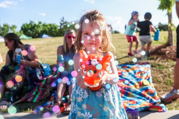 Willa Jackson, 2, blows bubbles at the SweetWater 420 Festival on Friday, April 17, 2026, at Shirley Clarke Franklin Park in Atlanta. (Abbey Cutrer/AJC)
