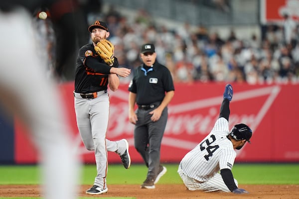 Baltimore Orioles' Jordan Westburg (11) throws to first base after forcing out New York Yankees' Jasson Domínguez (24) during the fifth inning of a baseball game Friday, June 20, 2025, in New York. (AP Photo/Frank Franklin II)