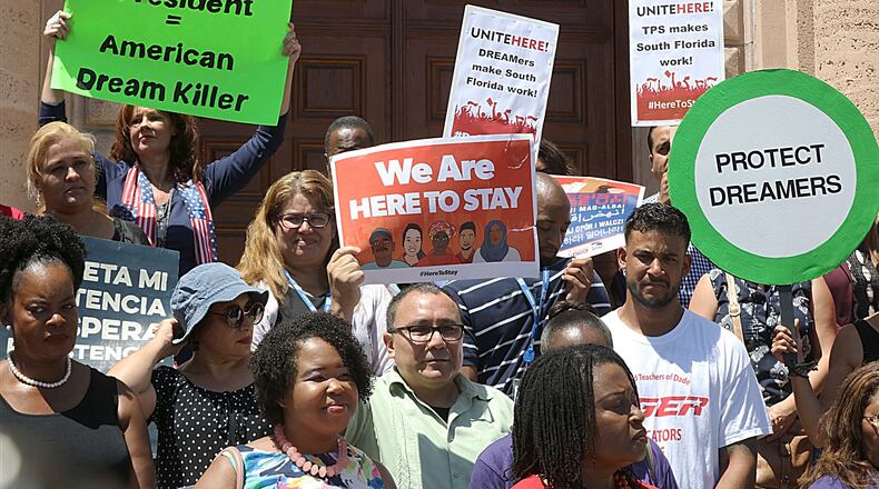 A group attends a rally to defend the Deferred Action for Childhood Arrivals (DACA) program in front of the MDC Freedom Tower in Miami, on Tuesday Sept. 5, 2017. (Pedro Portal/Miami Herald via AP)