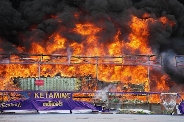 Smoke and flame rise from burning illegal narcotics during a destruction ceremony to mark International Day against Drug Abuse and Illicit Trafficking, on the outskirts of Yangon, Myanmar, Thursday, June 26, 2025. (AP Photo/Thein Zaw)