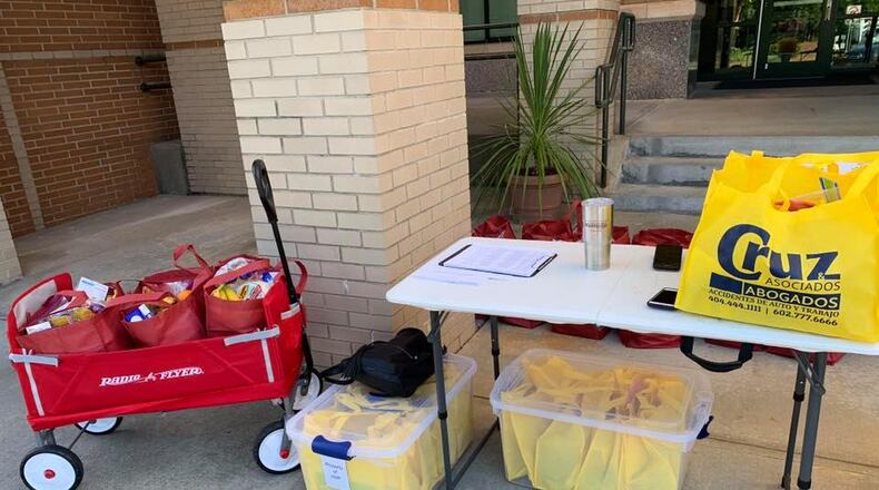 Students picked up supplies this week for the virtual summer camp sponsored by Hispanic Mentoring Program of Gwinnett County Public Schools. CONTRIBUTED