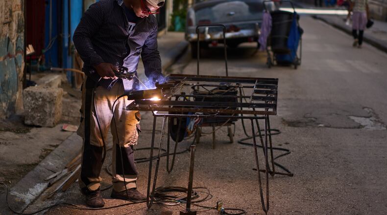A blacksmith welds a door in Havana, Cuba, Tuesday, June 9, 2026. (AP Photo/Ramon Espinosa)