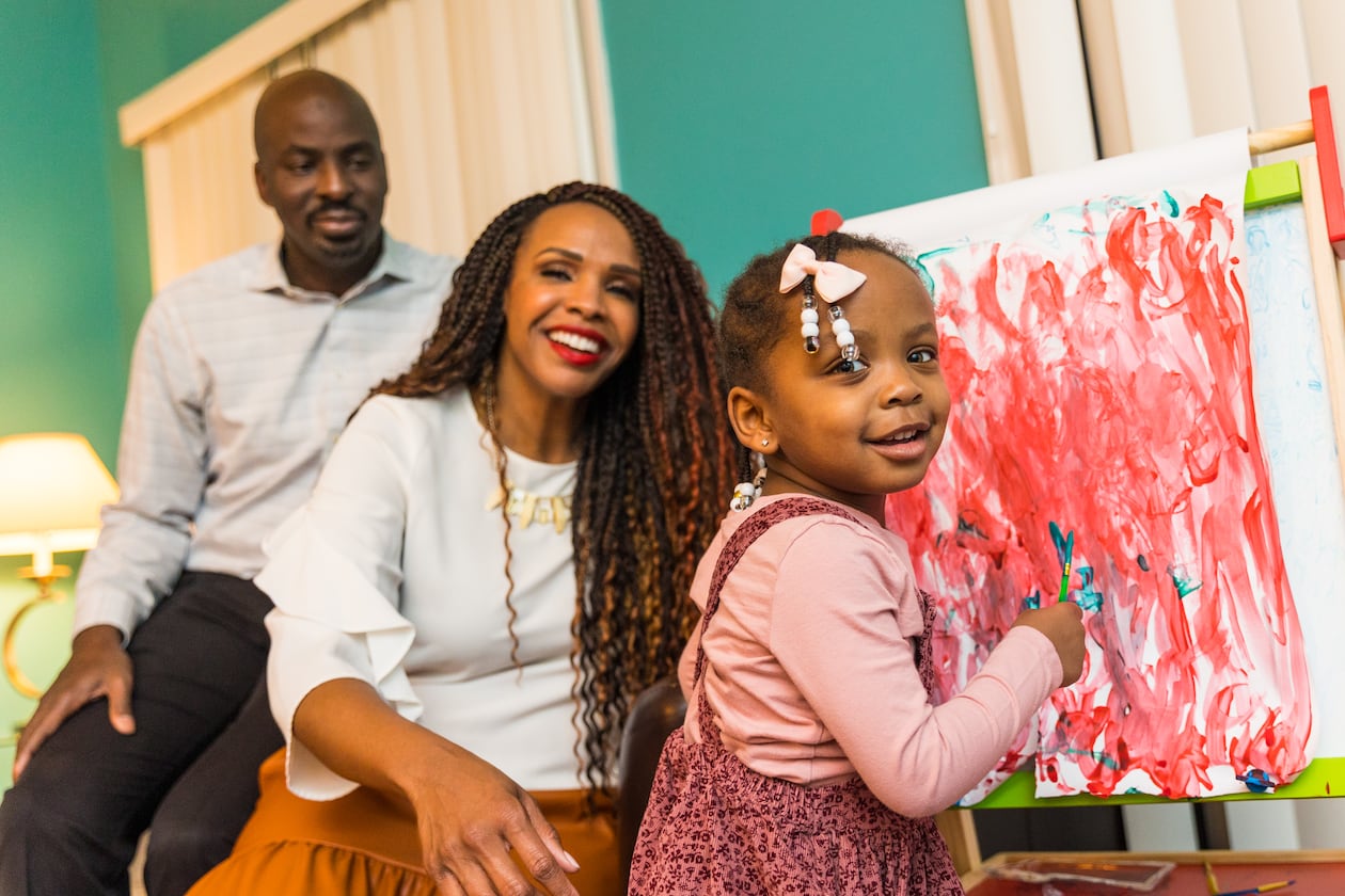 The McCown family is busy with their 2-year-old Priya McCowan, who turns three in early March and just added to her painting at their home. Emanuel and Penelope McCowan struggled for years with fertility issues. Penelope now has a blog and a small business to help others in her situation. (Jenni Girtman for The Atlanta Journal-Constitution)