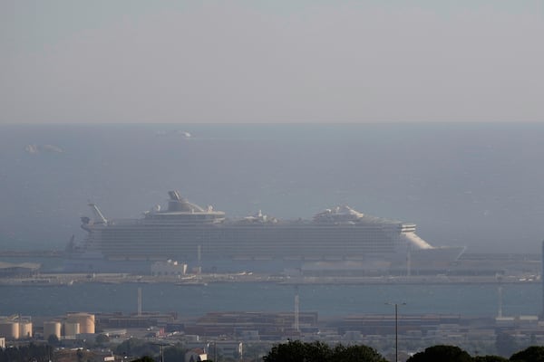A cruise ship is seen through the smoke during a wild fire Tuesday, July 8, 2025 in the port of Marseille, southern France. (AP Photo/Lewis Joly)