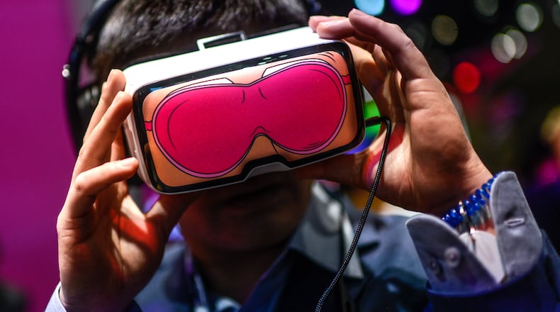 BARCELONA, SPAIN - FEBRUARY 23: A visitor uses a Oculus VR virtual reality device at the Deutsche Telekon pavilion on day 2 of the Mobile World Congress on February 23, 2016 in Barcelona, Spain. The annual Mobile World Congress hosts some of the world's largest communications companies, with many unveiling their latest phones and wearables gadgets.  (Photo by David Ramos/Getty Images)