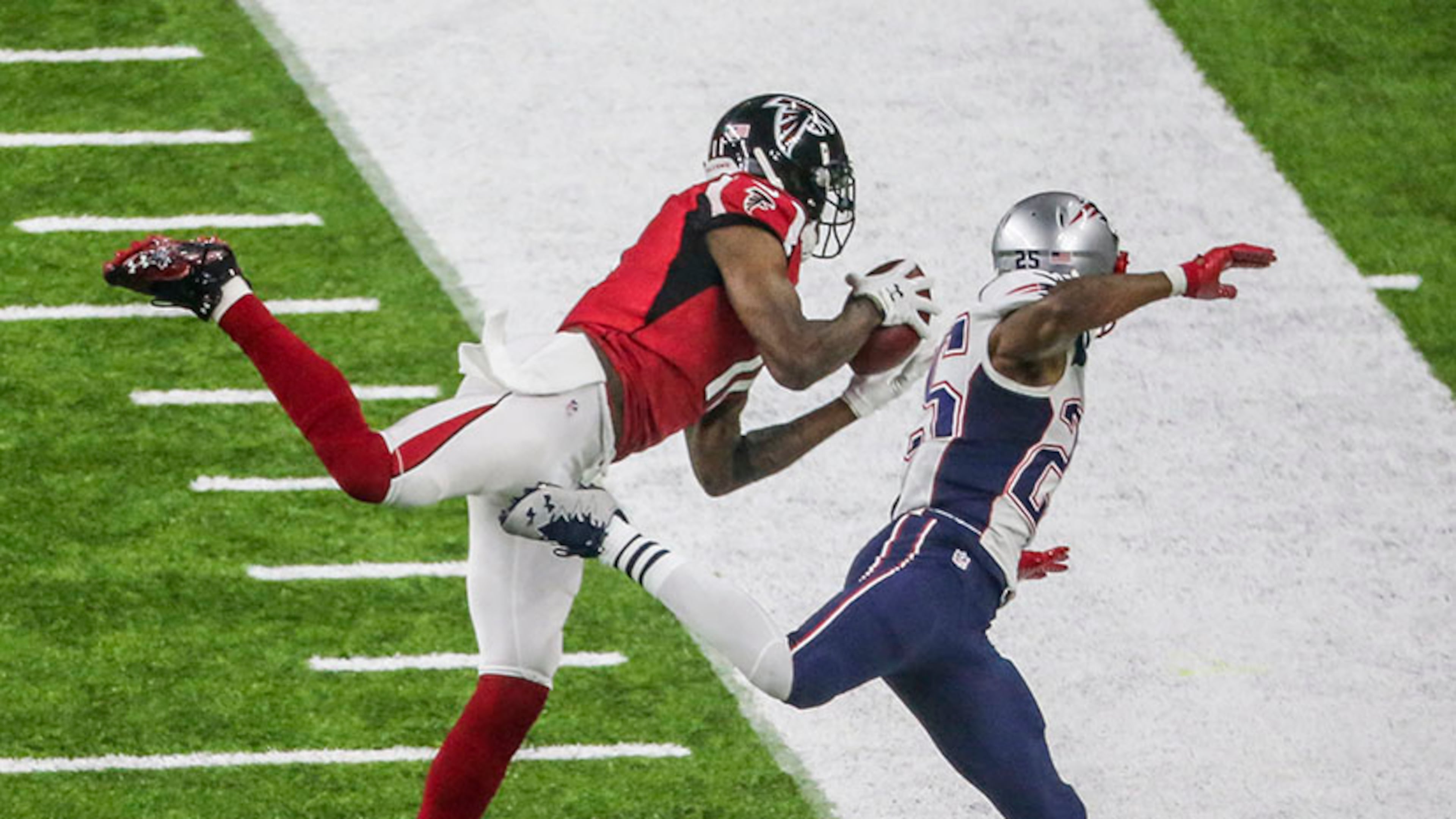 Julio Jones gets his first foot down as he makes an impressive catch over Patriots defender Eric Rowe during Super Bowl LI Feb. 5, 2017, at NRG Stadium in Houston. (John Spink/AJC file)