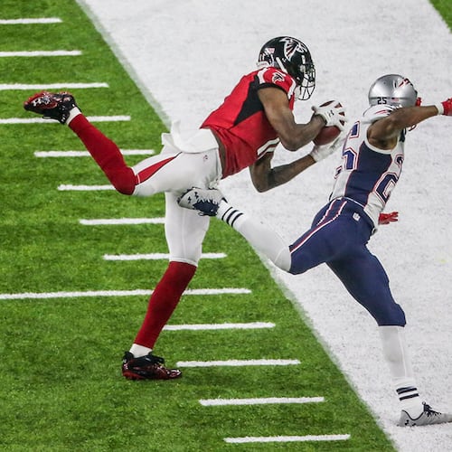 Julio Jones gets his first foot down as he makes an impressive catch over Patriots defender Eric Rowe during Super Bowl LI Feb. 5, 2017, at NRG Stadium in Houston. (John Spink/AJC file)
