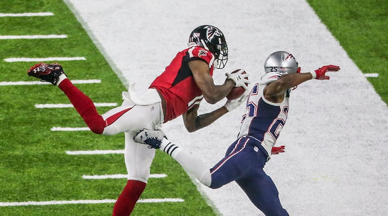 Julio Jones gets his first foot down as he makes an impressive catch over Patriots defender Eric Rowe during Super Bowl LI Feb. 5, 2017, at NRG Stadium in Houston. (John Spink/AJC file)