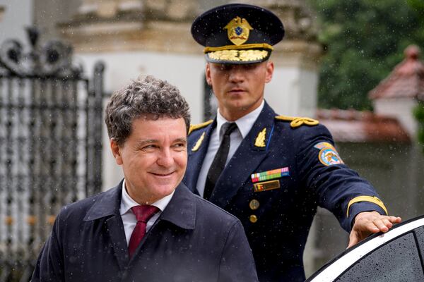 Romania's newly elected president Nicusor Dan arrives at the Cotroceni Presidential Palace to attend a welcoming ceremony, after being sworn in at the parliament, in Bucharest, Romania, Monday, May 26, 2025. (AP Photo/Andreea Alexandru)