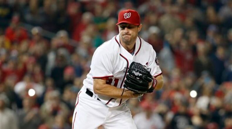 Washington Nationals starting pitcher Max Scherzer reacts during an interleague baseball game against the Detroit Tigers at Nationals Park, Wednesday, May 11, 2016, in Washington. Scherzer struck out 20 batters tying the major league nine-inning record. The Nationals won 3-2. (AP Photo/Alex Brandon)