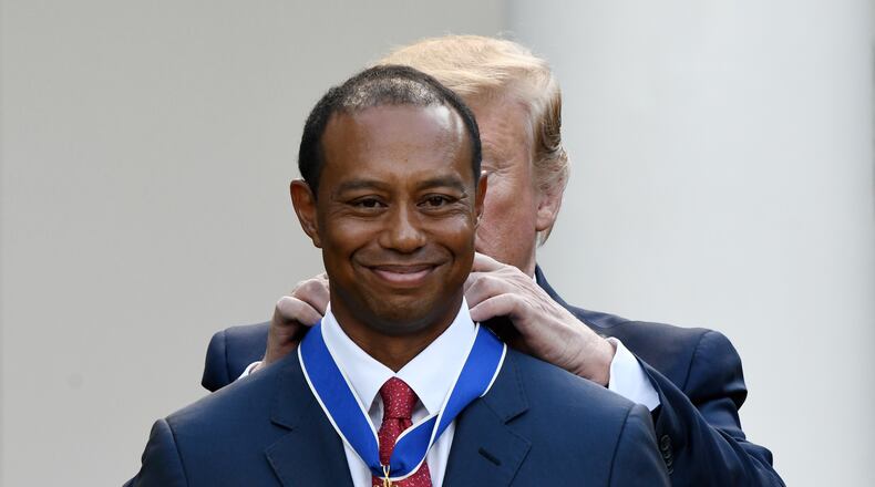 Tiger Woods happily receives the nation's highest civilian honor, the Presidential Medal of Freedom, during a ceremony in the Rose Garden at the White House. (Olivier Douliery/Abaca Press/TNS)