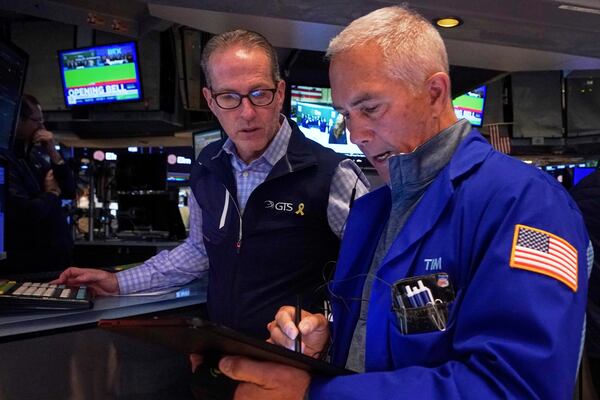 Specialist Glenn Carell, left, and trader Timothy Nick work on the floor of the New York Stock Exchange, Wednesday, April 23, 2025. (AP Photo/Richard Drew)
